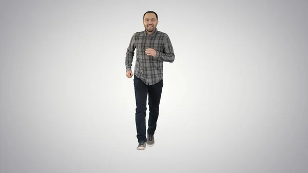 Young man running excited on gradient background. — Stock Photo, Image