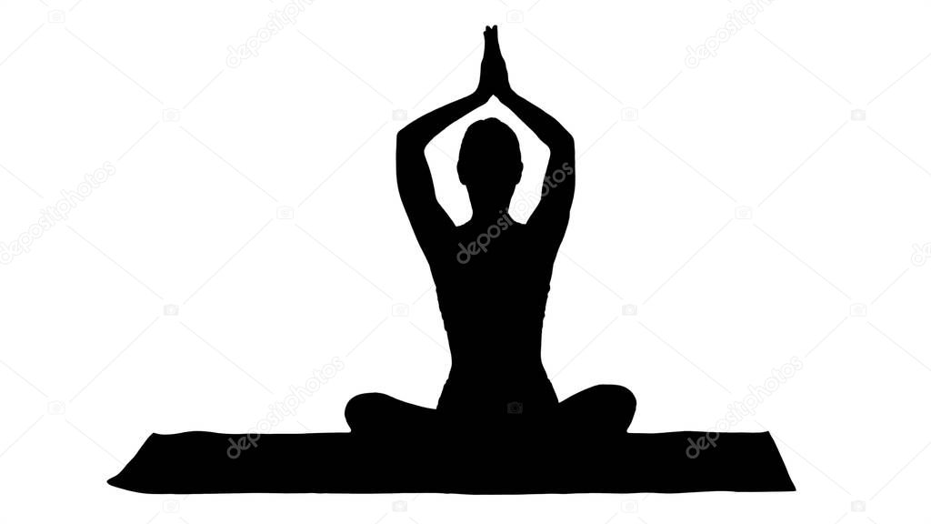 Silhouette Young sporty woman sitting in lotus pose, join hands