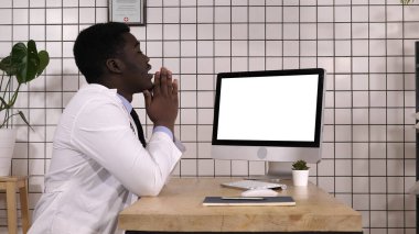 Şok olmuş tıp doktoru bilgisayar ekranına bakıyor. Beyaz