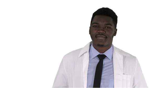 Hombre africano médico de pie con las manos en los bolsillos en blanco —  Fotos de Stock