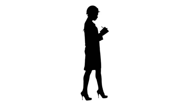 Silhouette Woman engineer with helmet is holding pen and checkli — Stock Photo, Image