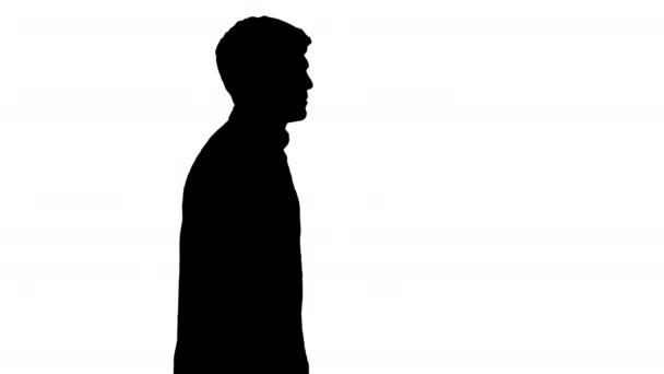 Silhouette Casual young man walking and looking forward. — Stock Video