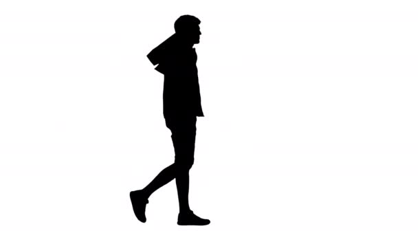 Silhouette Όμορφος άνθρωπος σε casual ρούχα με τα πόδια με τσάντες ψώνια κοιτάζοντας κάμερα. — Αρχείο Βίντεο