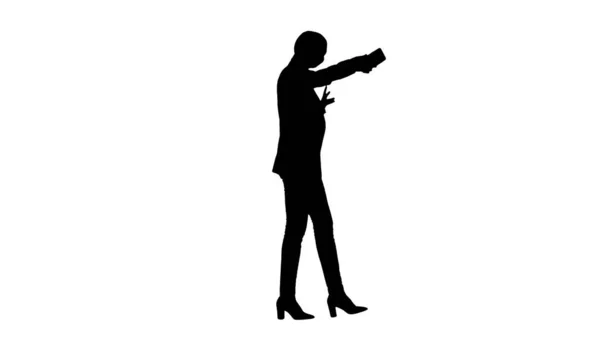 Silhouette Smiling Businesswoman taking selfie on her phone whil — Stock Photo, Image
