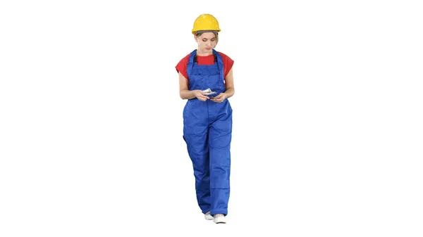 Female constuction worker counting money while walking on white — Stock Photo, Image