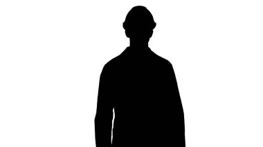 Siluet Bilim Mühendisi güvenlik kaskı ve gözlüklerle yürüyor.