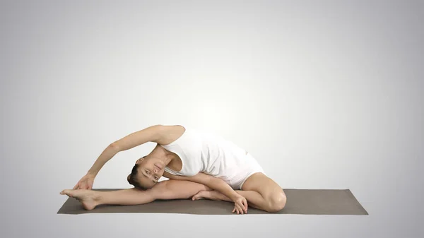 Belle jeune femme portant des vêtements blancs faisant de l'exercice de yoga — Photo