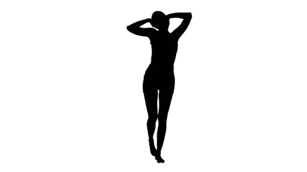 Silhouette Donna che fa stretching mattutino mentre cammina. — Foto Stock