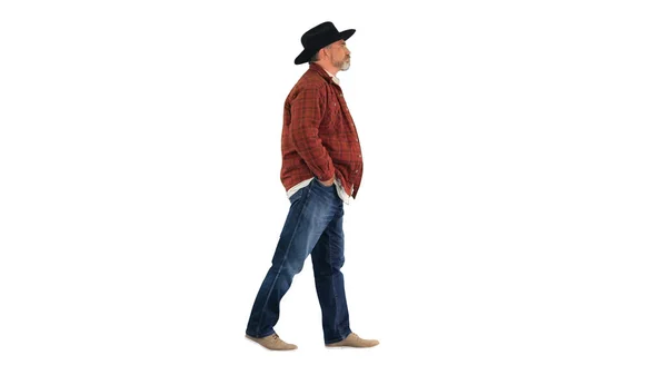 Senior farmer with hat walking on white background. — Stock Photo, Image