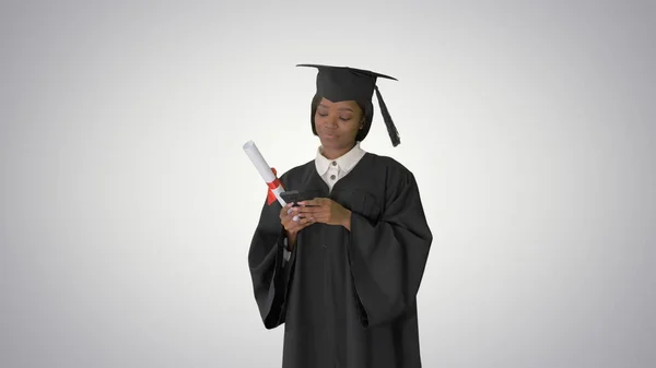 Happy African American female graduate holding diploma and texti — Stock Photo, Image