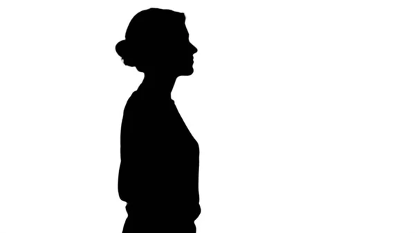 Silhouette Young beautiful girl with hands in pockets walking. — Stock Photo, Image