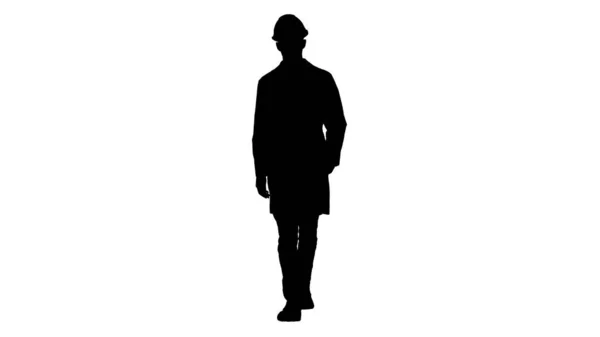 Silhouette Ingeniero árabe en casco y bata blanca caminando hacia adelante. — Foto de Stock