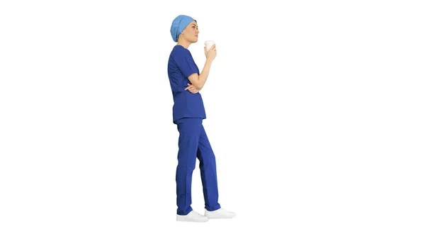 Leende kvinnlig läkare eller sjuksköterska i blå uniform med kaffe b — Stockfoto