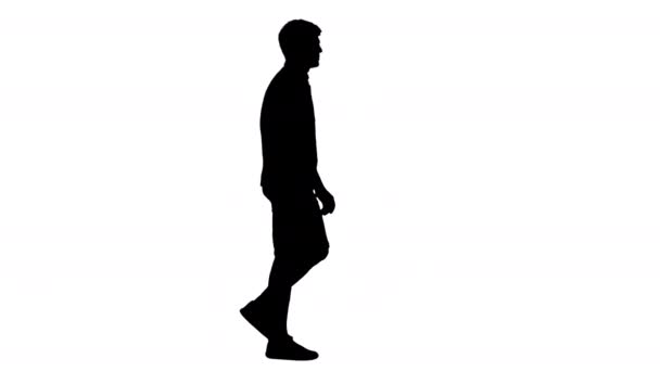 Silhouet Casual jongeman wandelen en kijken uit naar. — Stockvideo
