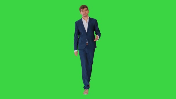 Geschäftsmann zu Fuß und erklärt etwas vor der Kamera auf einem Green Screen, Chroma Key. — Stockvideo