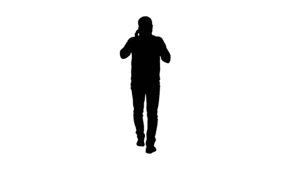 Silhouette Poważny człowiek chodzący i mówiący przez komórkę. — Zdjęcie stockowe