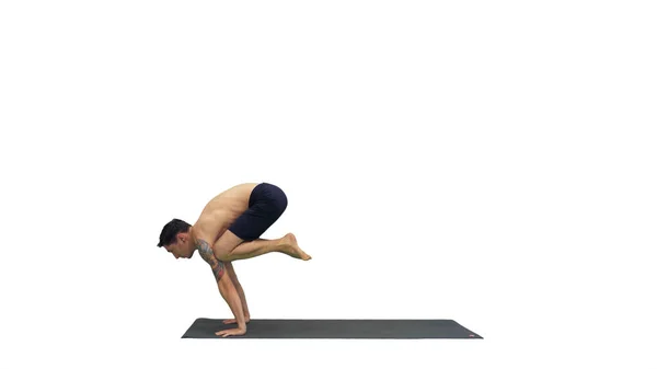 Hombre guapo haciendo asanas de yoga sobre fondo blanco. —  Fotos de Stock