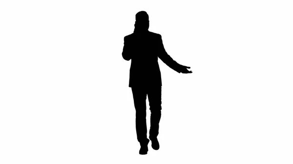 Silhouette Successful man in suit speaks on phone and walks. — Stock Photo, Image