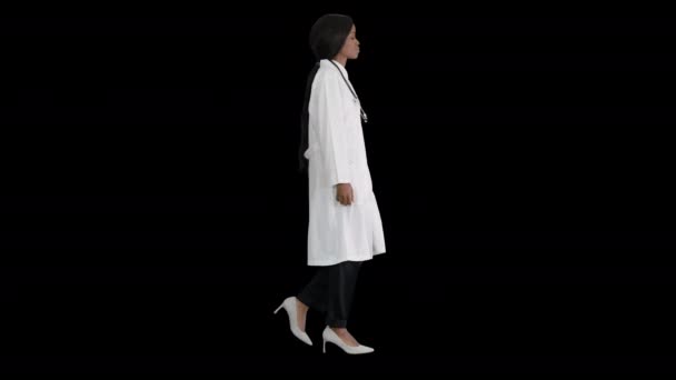 Sad African american female doctor walking with hands in her pockets, Alpha Channel — Stock Video