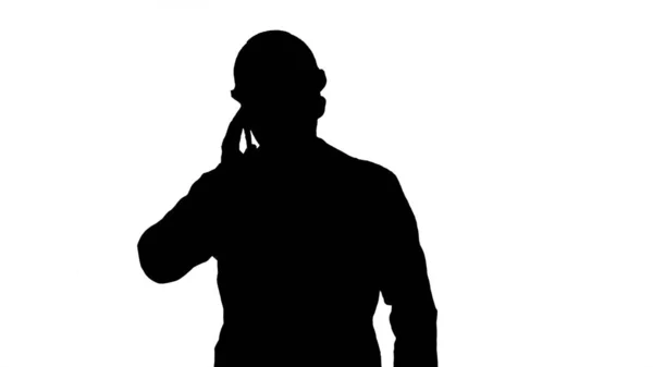 Silhouette Engineer in protective glasses and hat walking, takin — Stock Photo, Image