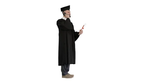 Happy graduated young man in cap and gown talking with parent on — Stock Photo, Image