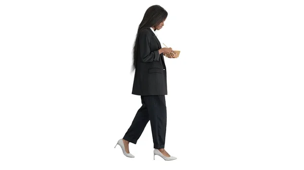 Pretty young black woman writing in notepad on white background. — Stock Photo, Image