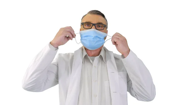 Male Doctor taking off protective Medical mask and smiling to ca — Stock Photo, Image