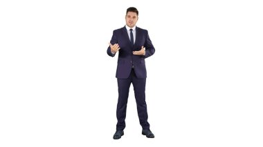 Yakışıklı iş adamı kameraya bakıyor ve beyaz sırtında konuşuyor.