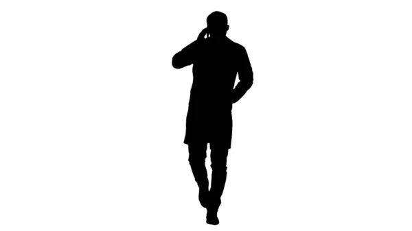 Silhouette Male doctor walking and talking on the phone. — Stock Photo, Image