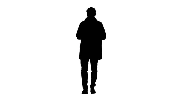 Silhouette Young man wearing trench coat talking to camera. — Stock Photo, Image
