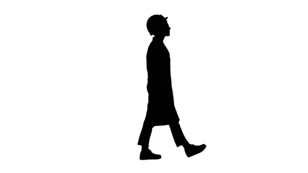Silhouette Walking woman engineer with hands in pockets. — Stock Photo, Image