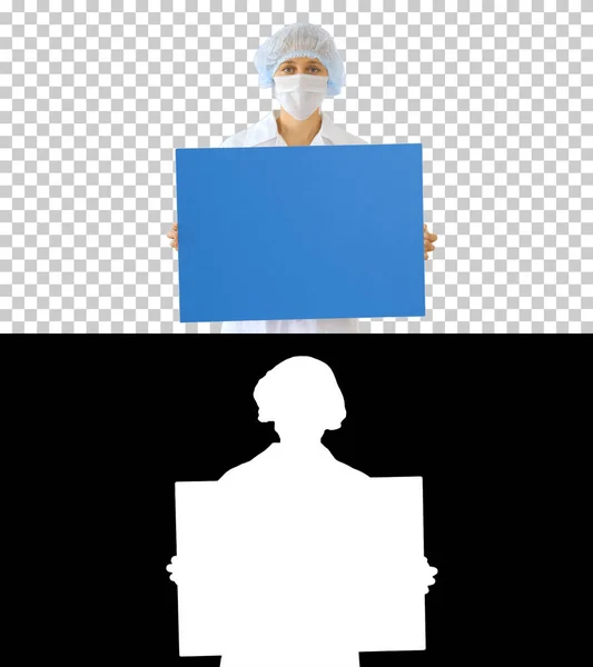 Woman doctor in a mask holding an empty board, Alpha Channel