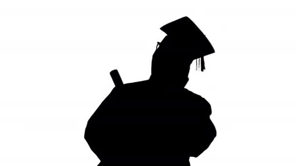 Silhouette Smiling african american male student in graduation robe talking on the phone sharing happy news. — Stok Video