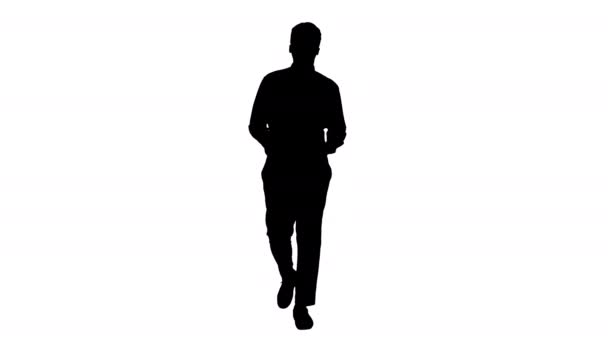 Silhouette Young African american businessman gesturing and talking to camera while walking. — Stock Video