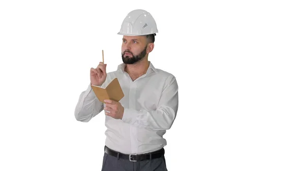 Confident mature man in formalwear and hardhat writing down note — Stock Photo, Image