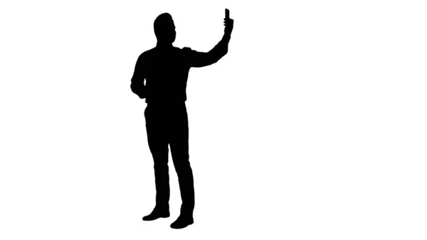 Silhouette Happy young handsome businessman recording vlog or making video call. — Stock Photo, Image