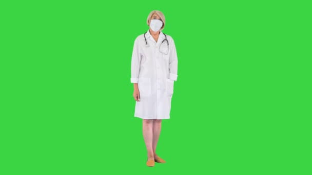 Médecin principale pendant une pandémie de coronavirus covid-19 enlève le masque de protection sur un écran vert, Chroma Key. — Video