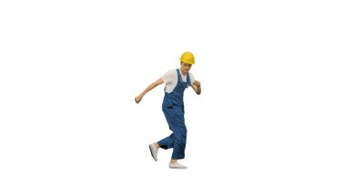 Sarı şapkalı genç inşaat işçisi break dans yapıyor.