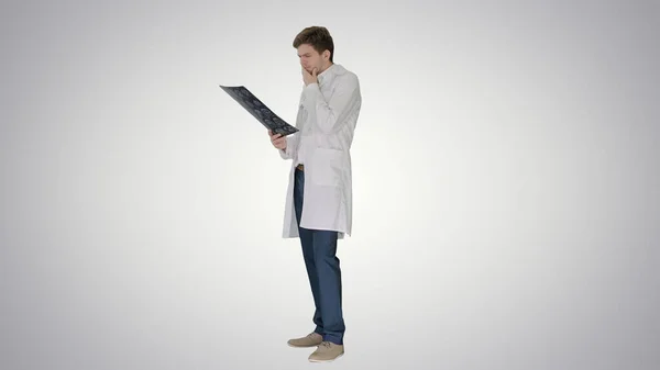 Concentrated male doctor looking at computed tomography xray ima — Stock Photo, Image