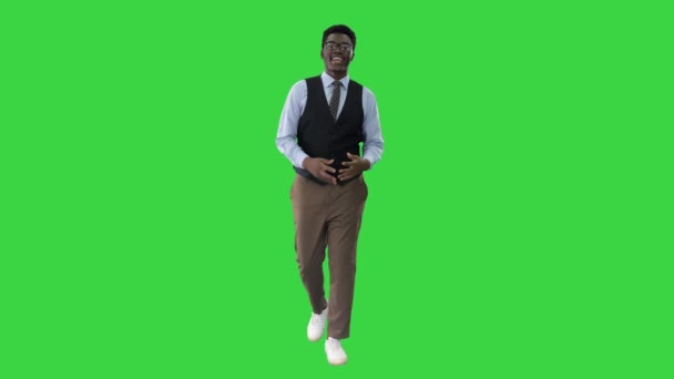 Young African american businessman gesturing and talking to camera while walking on a Green Screen, Chroma Key. — Stock Video