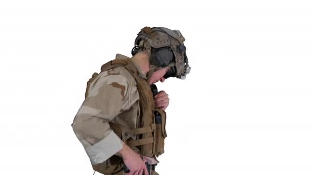 Soldier standing and talking on the radio on white background. — Stock Video