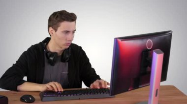 Oyuncu, gradyan arkaplanda kişisel bilgisayarda bir video oyunu oynuyor.