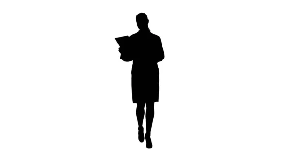 Silhouette Happy female doctor using tablet computer turning pag — Stock Photo, Image