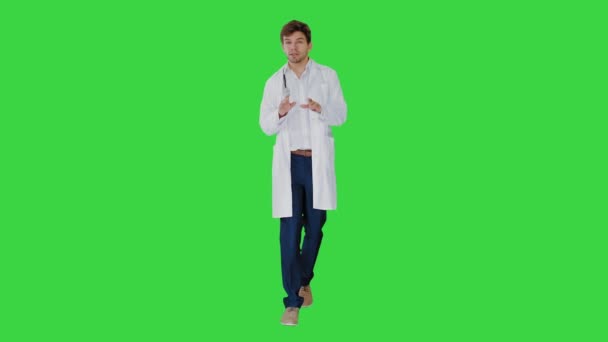 Doktor mluví s fotoaparátem při chůzi na zelené obrazovce, Chroma Key. — Stock video