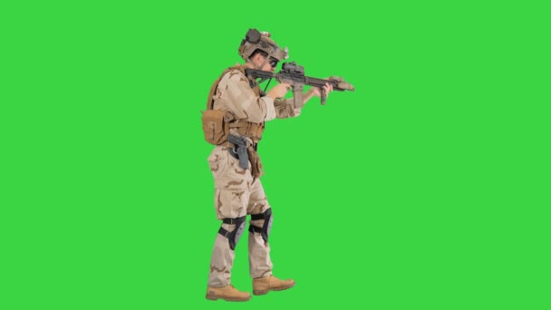 Soldier of special force walking and shooting on a Green Screen, Chroma Key. — Stock Video