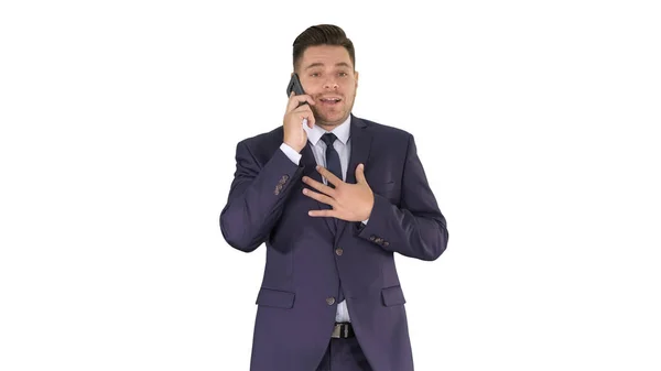 Successful man in suit speaks on phone and walks on white background. — Stock Photo, Image