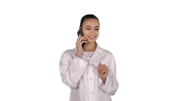 Smiling female doctor on the phone talking while walking on whit — Stock Photo, Image