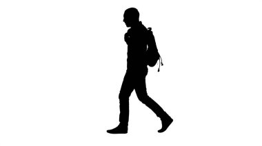 Siluet Genç erkek öğrenci izole yeşil sırtında yürüyor