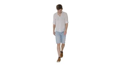 Sıradan bir genç adam beyaz arka planda yürüyor ve ileriye bakıyor.