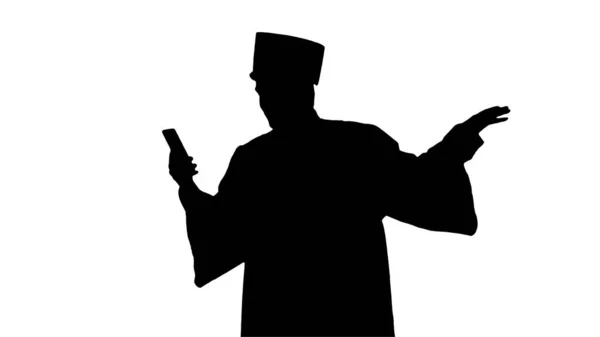 Silhouette Smiling male student in graduation gown showing campu — Stock Photo, Image